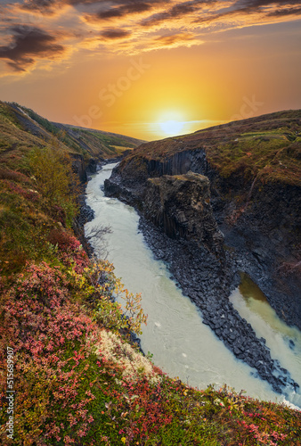 Autumn  picturesque dusk Studlagil canyon is a ravine in Jokuldalur, Eastern Iceland. Famous columnar basalt rock formations and Jokla river runs through it. photo