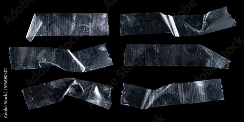 Cuadro en lienzo Set of transparent adhesive plastic tape pieces isolated on black background,Cru