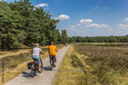 People riding their bicycle in national park Dwingelderveld in Drenthe, Netherlands photo