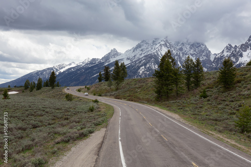 Scenic Road surrounded by Mountains in American Landscape. Spring Season. Grand Teton National Park. Wyoming, United States. Nature Background.