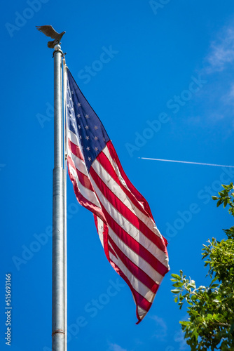 American flag with plane flying in the background in Prescott, Arizona