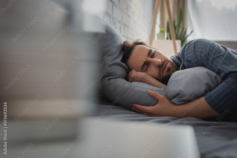 Young man sleeping on bed at home in morning Young man sleeping on bed at home in morning
