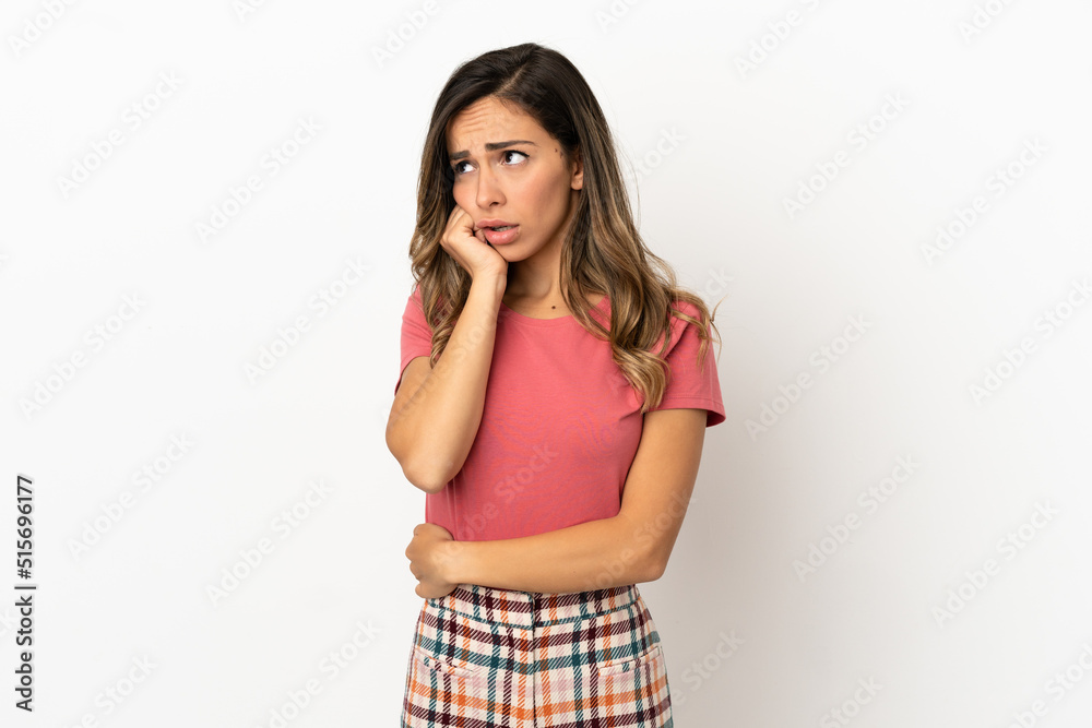Young woman over isolated background is a little bit nervous Young woman over isolated background is a little bit nervous