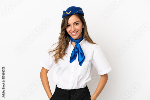 Airplane stewardess over isolated white background laughing