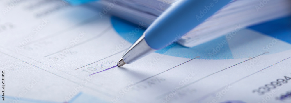 Accounting document with pen, money, coins and checking financial chart. Concept of banking, financial report and financial audit. Accounting document with pen, money, coins and checking financial chart. Concept of banking, financial report and financial audit.