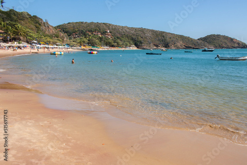 Fototapeta Naklejka Na Ścianę i Meble -  Beautiful beach of Jao Fernandez, in Buzios, Brazil, on a sunny day, surrounded by hills and blue water. 