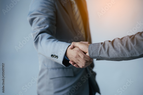 Close up of a man wear suite and have a handshaking with partner and colleague.