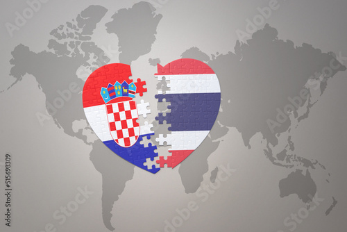 puzzle heart with the national flag of croatia and thailand on a world map background.Concept.