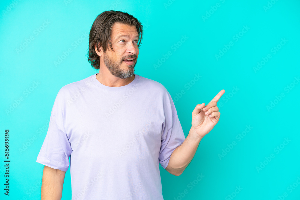 Senior dutch man isolated on blue background intending to realizes the solution while lifting a finger up Senior dutch man isolated on blue background intending to realizes the solution while lifting a finger up