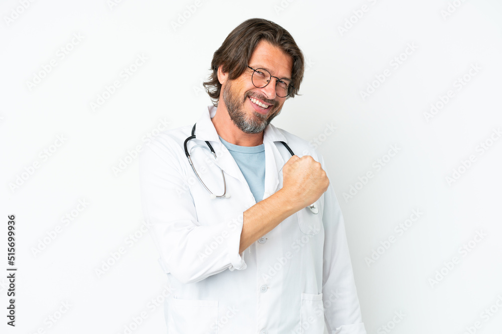 Senior dutch man isolated on white background wearing a doctor gown and making victory gesture Senior dutch man isolated on white background wearing a doctor gown and making victory gesture