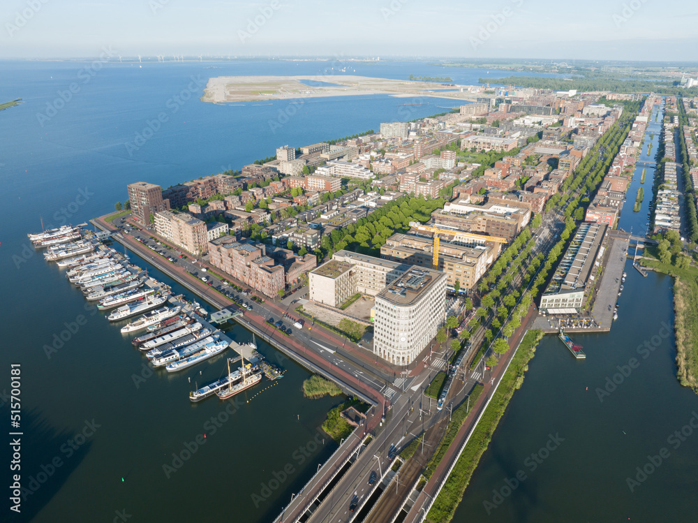 Amsterdam Ijburg artificial island modern residential area smart city cityscape at water Ijmeer. Urban houses buildings city environment area.
