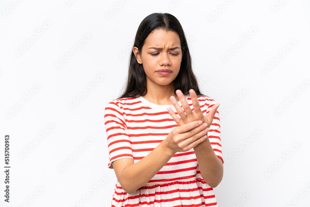 Young Colombian woman isolated on white background suffering from pain in hands Young Colombian woman isolated on white background suffering from pain in hands