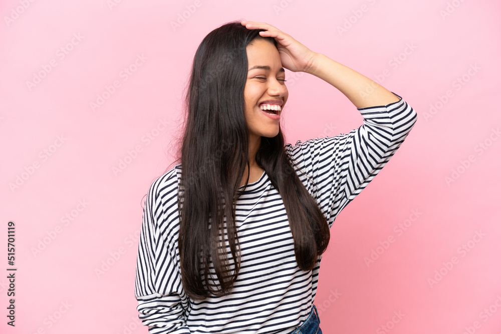 Young Colombian woman isolated on pink background smiling a lot Young Colombian woman isolated on pink background smiling a lot