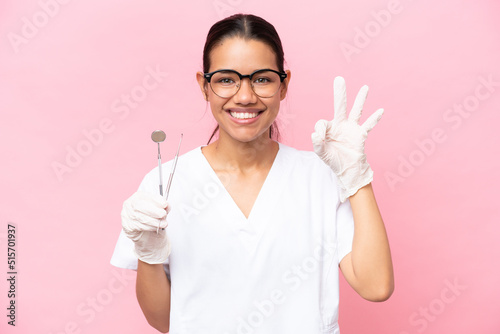 Dentist Colombian woman isolated on pink background showing ok sign with fingers