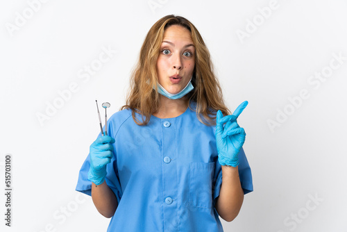 Woman dentist holding tools isolated on white background intending to realizes the solution while lifting a finger up