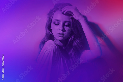 Young beauty girl with blond wavy hair and makeup closed her eyes and enjoys the silence, stylish woman