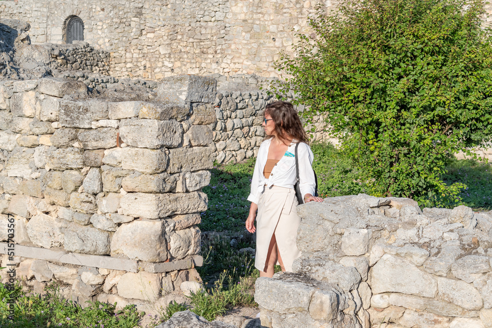 A girl walks through the ruins of an ancient ancient city