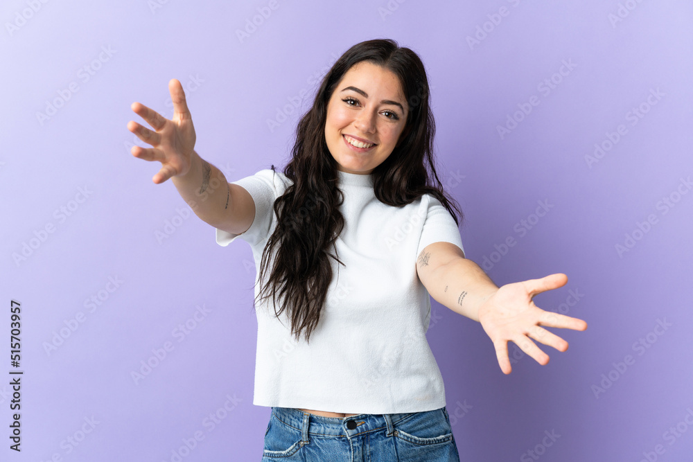 Young caucasian woman isolated on purple background presenting and inviting to come with hand Young caucasian woman isolated on purple background presenting and inviting to come with hand