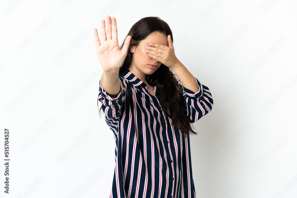 Young caucasian woman over isolated background making stop gesture and covering face Young caucasian woman over isolated background making stop gesture and covering face