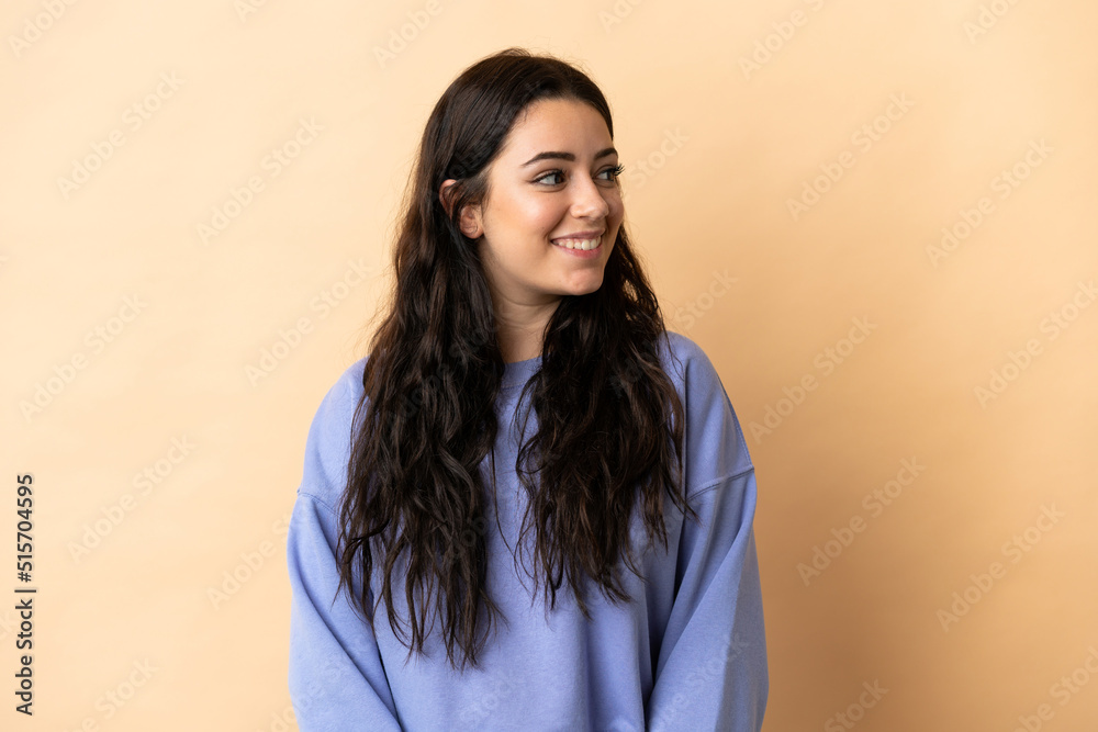 Young caucasian woman over isolated background looking side