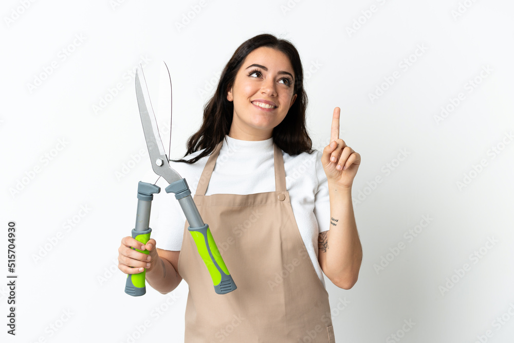 Young caucasian woman holding a plant isolated on white background pointing up a great idea Young caucasian woman holding a plant isolated on white background pointing up a great idea
