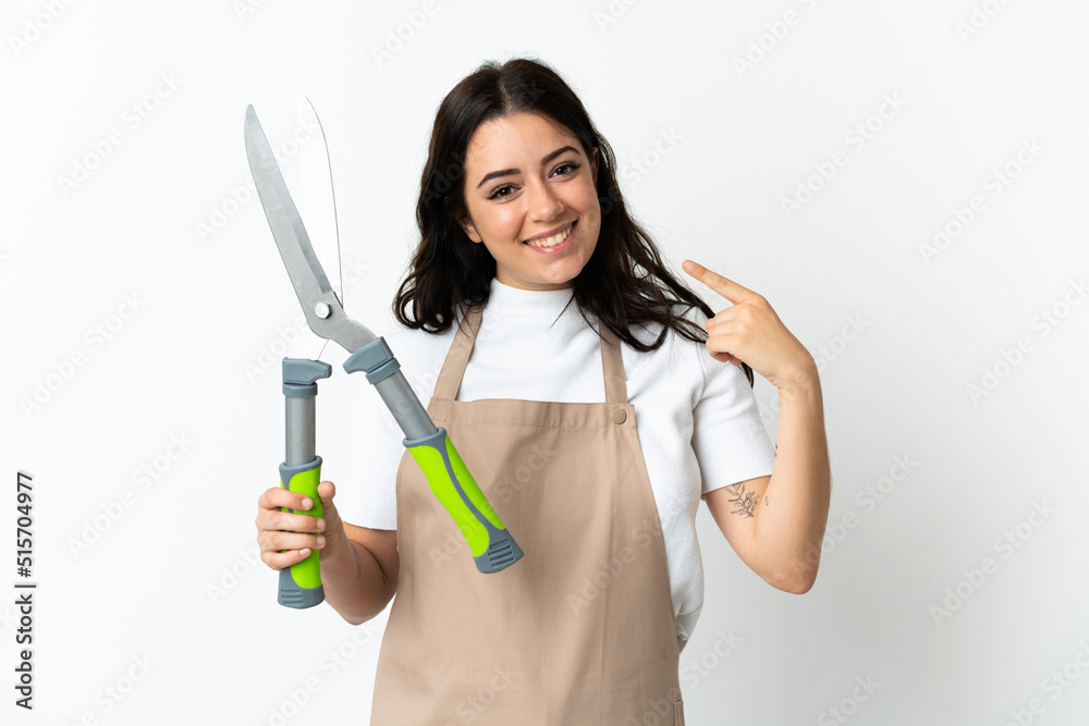 Young caucasian woman holding a plant isolated on white background giving a thumbs up gesture Young caucasian woman holding a plant isolated on white background giving a thumbs up gesture
