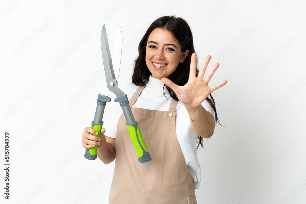 Young caucasian woman holding a plant isolated on white background counting five with fingers Young caucasian woman holding a plant isolated on white background counting five with fingers