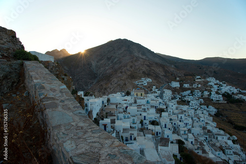 Sunset over the mountain above the Chora town with traditional white houses on Serifos island in Greece