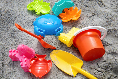 Children toys: bucker, shovel, sand molds lie on the sand. Children's beach sand toys. photo