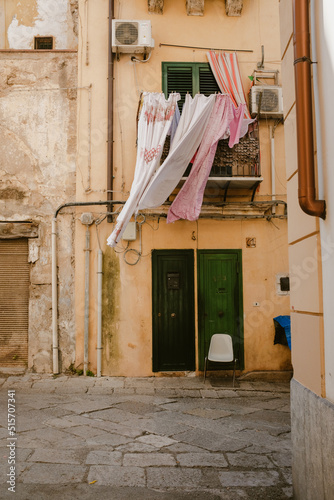 Fototapeta Naklejka Na Ścianę i Meble -  Narrow street in old town of palermo city in Italy with laundry hanging.
