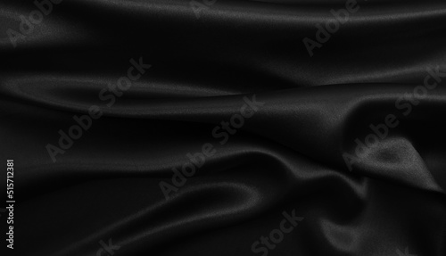 Smooth elegant black silk or satin texture as abstract background. Luxurious background design