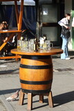 empty beer mugs and beer bottles on a wooden barrel table in munchen