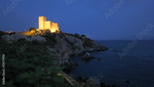 Aldobrandesca Rocca di Talamone fortress at night at the coastline of Tuscany, Italy photo