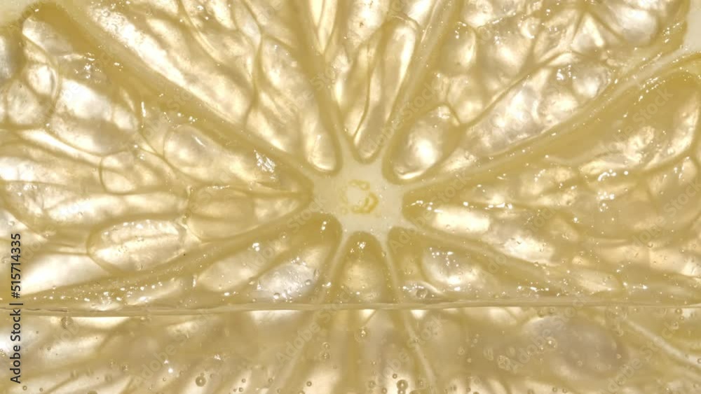 Water with Lemon Slices and exploding soda, air bubbles. Refreshing soft drink Lemon and sparkling water with ice. Macro shot. High quality 4k footage