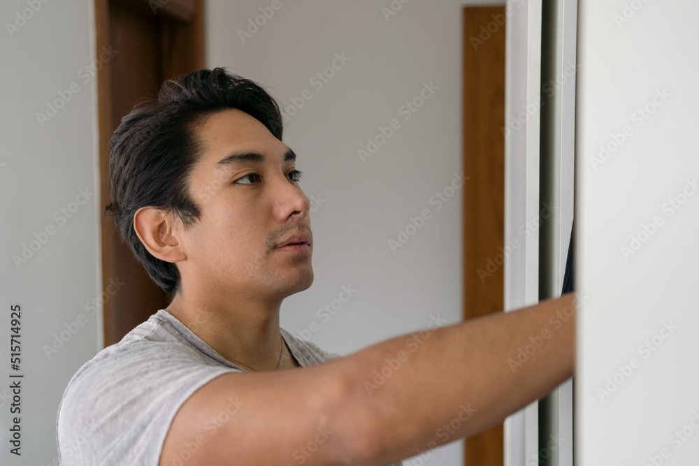 Latin man choosing clothing from his wardrobe Latin man choosing clothing from his wardrobe