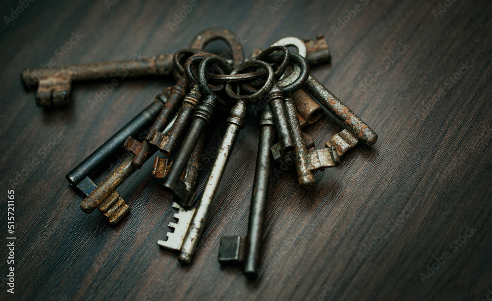 Bunch of old keys on dark wooden background, close up Bunch of old keys on dark wooden background, close up