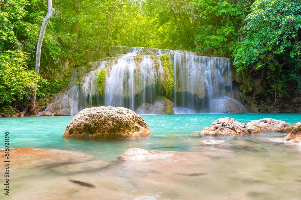 Fototapeta premium Erawan Waterfall beautiful rainforest with sunlight in Thailand