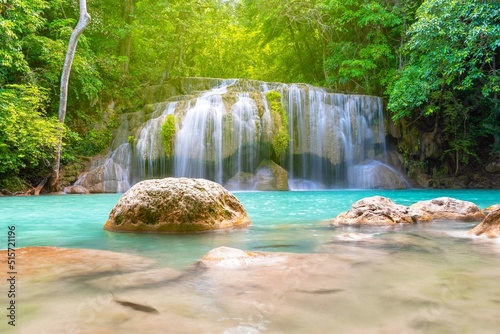 Erawan Waterfall beautiful rainforest with sunlight in Thailand