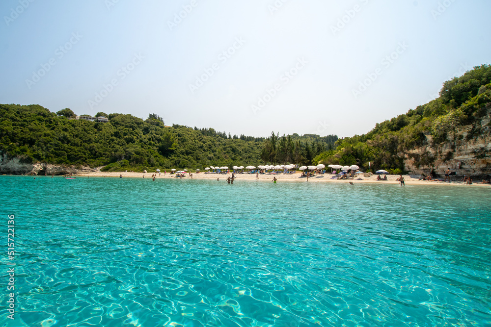 Turquoise exotic sea with people at the beach at Paxos island in Greece