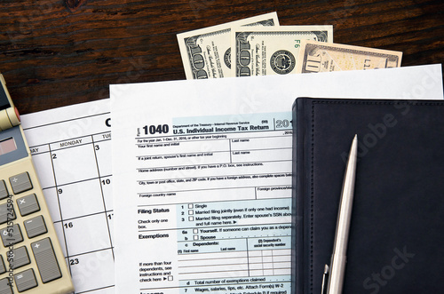 1040 US individual tax form, dollars, pen photo