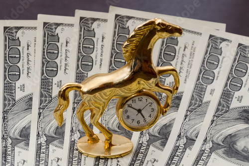 Time is money. Gold watch on 100 dollar bills. The concept of the transience of time