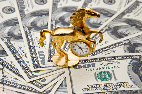 Old golden watch on the banknotes of 100 dollars