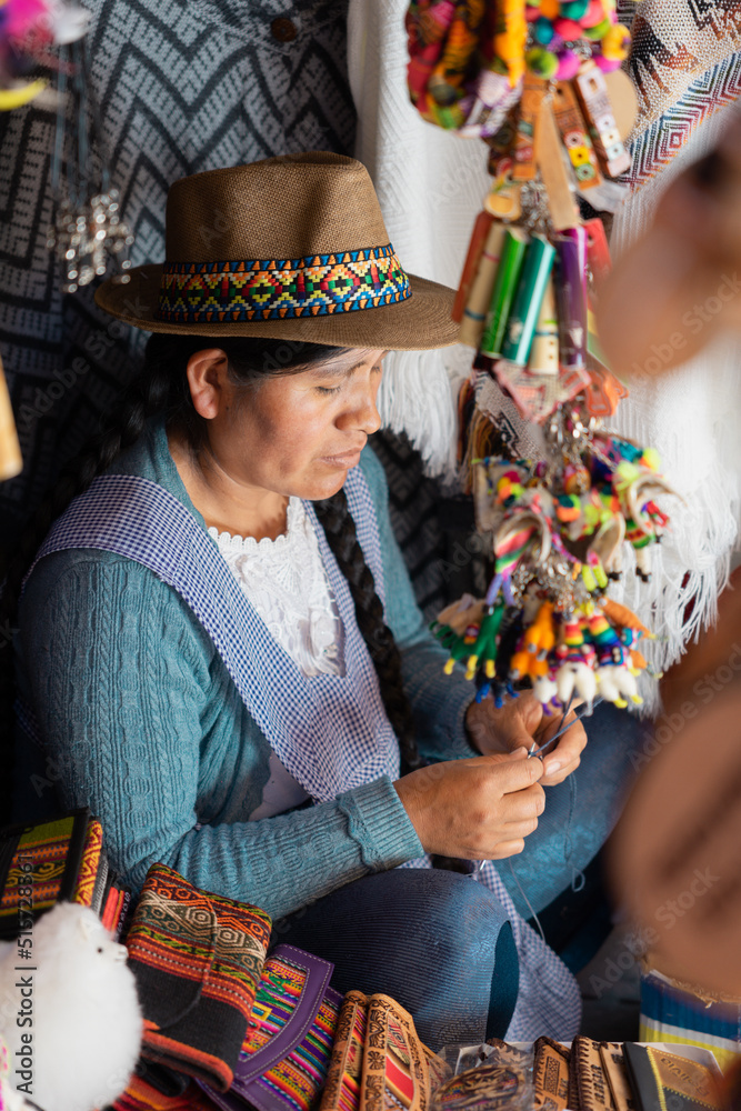 Latin woman weaving with wool in a handicraft shop
