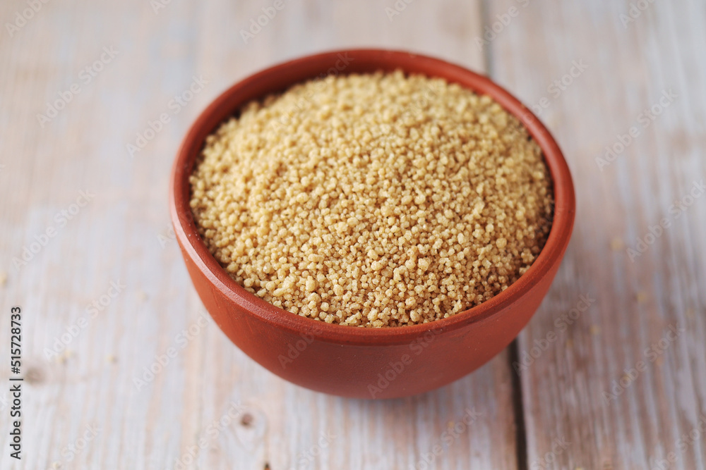 Dry couscous in a small ceramic bowl Dry couscous in a small ceramic bowl