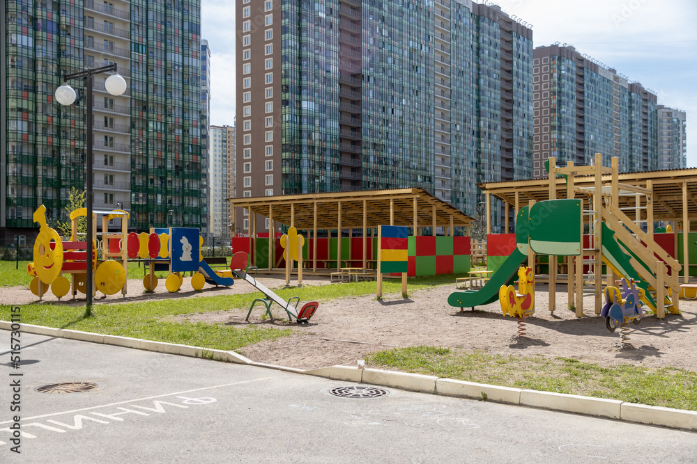 Children's playground in a modern complex of apartment buildings on a sunny day. The territory of the kindergarten.With outdoor amenities Children's playground in a modern complex of apartment buildings on a sunny day. The territory of the kindergarten.With outdoor amenities