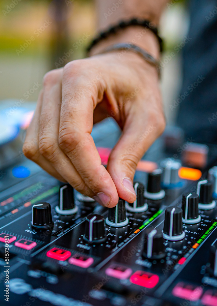 DJ Hands creating and regulating music on dj console mixer in concert outdoor DJ Hands creating and regulating music on dj console mixer in concert outdoor