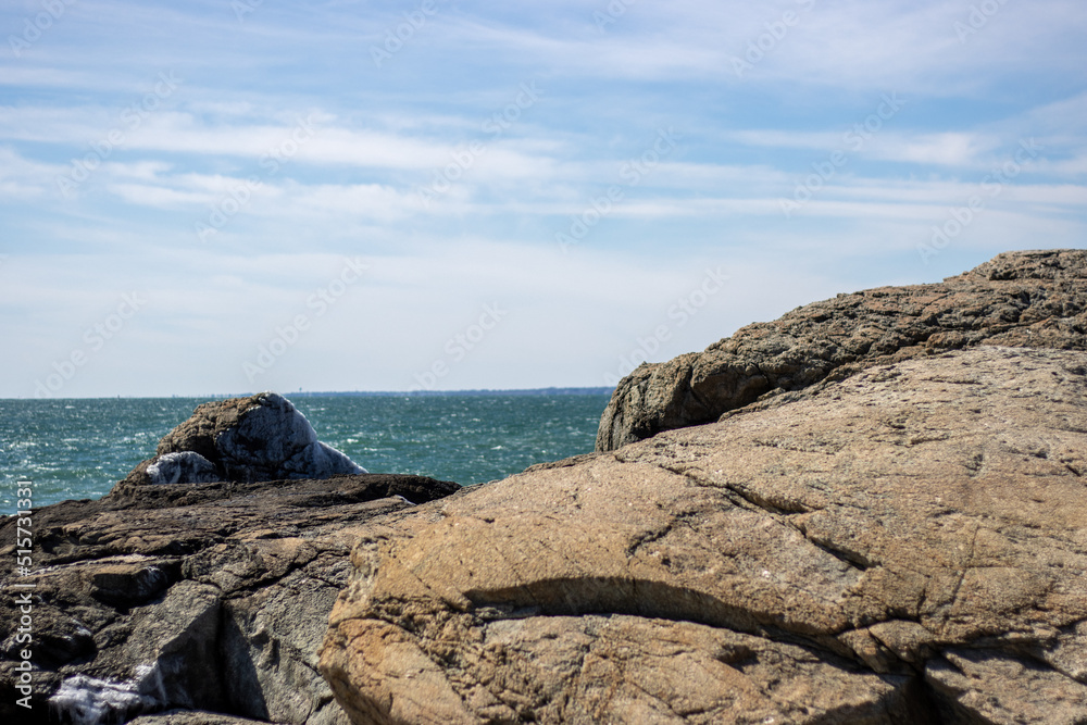 rocks overlooking ocean horizon with sunny sky rocks overlooking ocean horizon with sunny sky