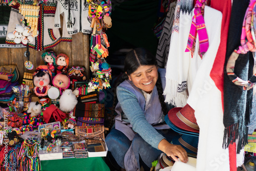 Latin woman smiling and working in a typical souvenir shop
