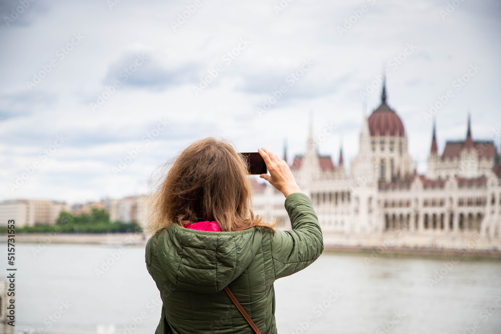 beautiful woman tourist in Budapest parliament building in background