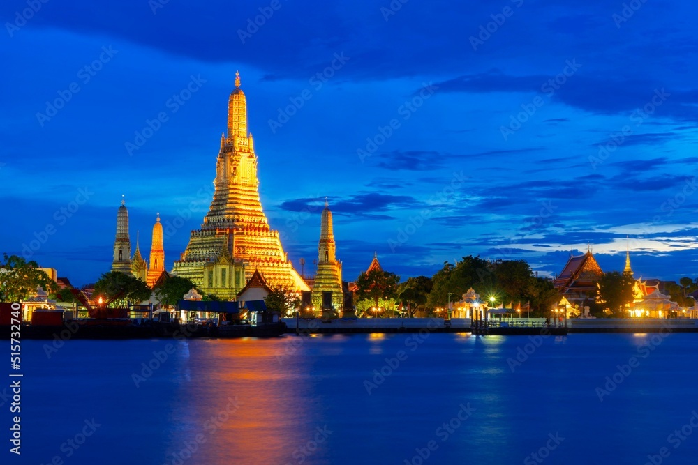 Wat Arun Temple with twilight blue water and sky in Bangkok Thailand